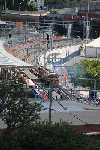 Two 2400-class locomotives run light engine past the new Exhibition station