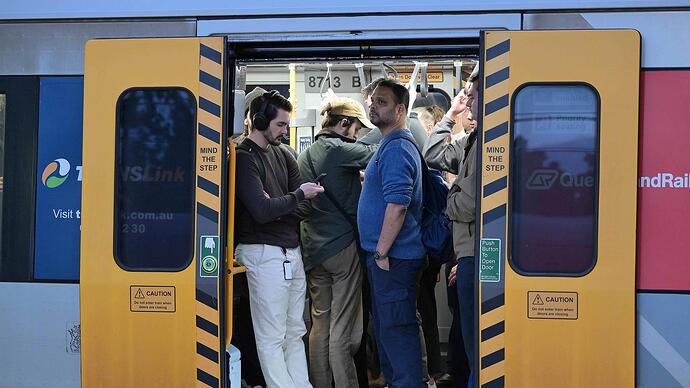 Peak hour passengers wait then board passenger trains at Roma Street Railway Station, Brisbane. Lyndon Mechielsen/Courier Mail