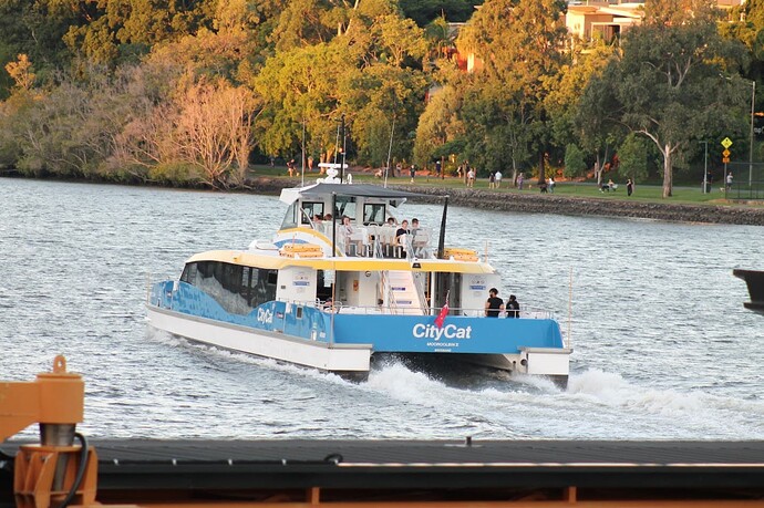 A CityCat pulls out of Regatta station on a summer afternoon